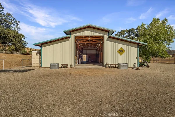 a view of a house with garage and parking area
