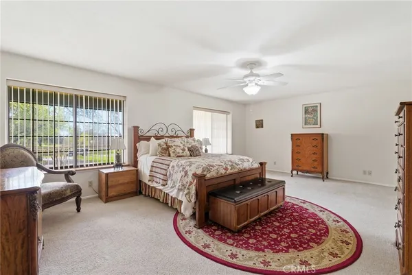 a bedroom with two beds and a chair