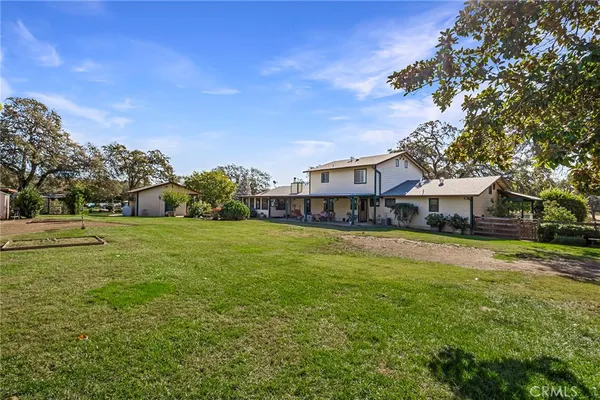 a view of a house with a backyard