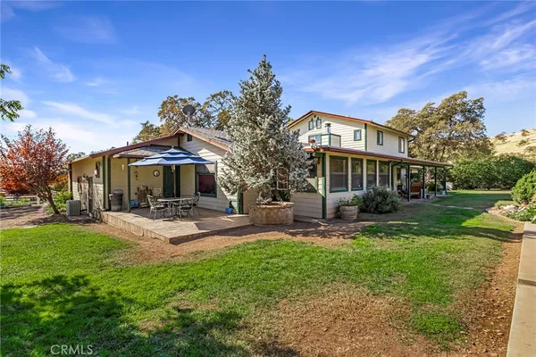 a view of a field with trees in the background