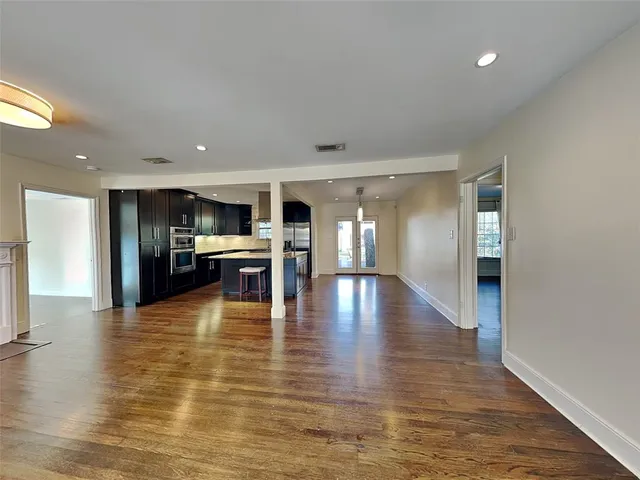 a view of kitchen with kitchen island refrigerator sink and wooden floor