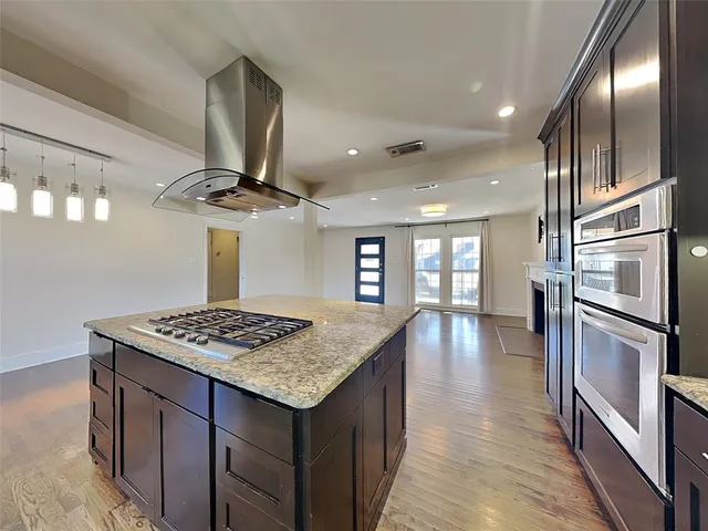 a kitchen with stainless steel appliances granite countertop a sink dishwasher stove and refrigerator