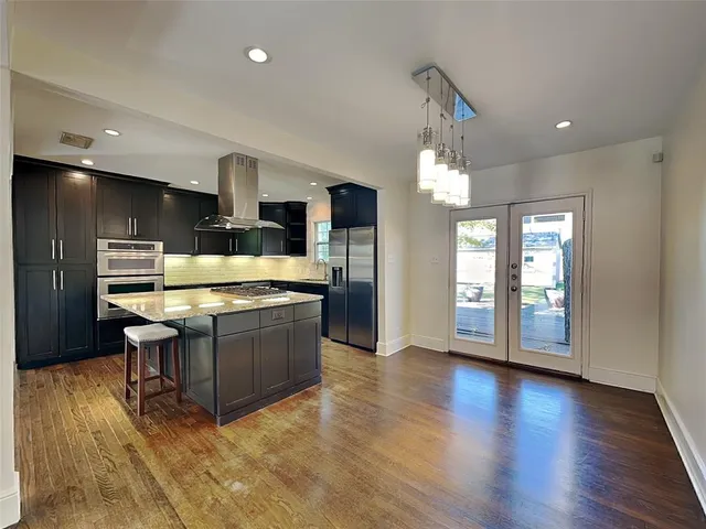 a large kitchen with a table and chairs in it