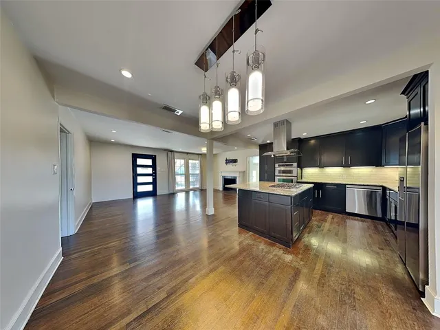 a view of a living room kitchen and a wooden floor
