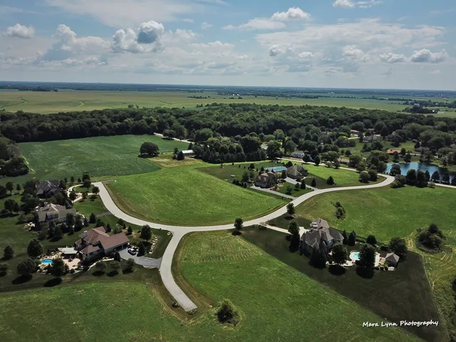 an aerial view of a golf course with chairs