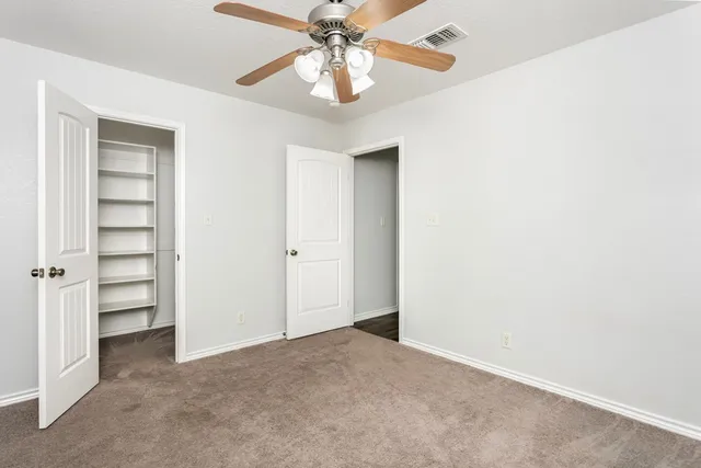 a view of empty room with closet and window