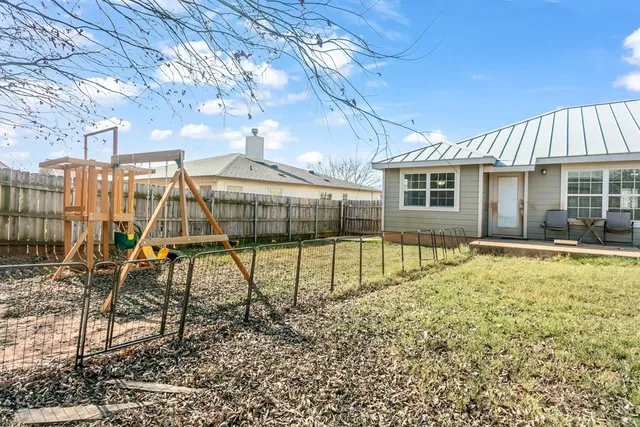 a house view with swimming pool in front of it
