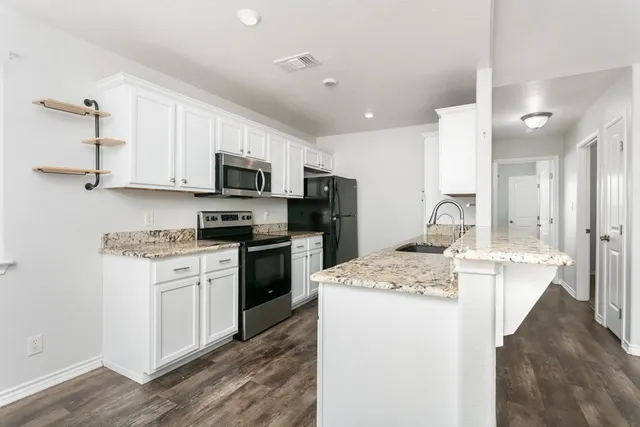 a kitchen with a sink stove and refrigerator