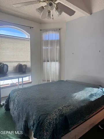 a bed sitting in a bedroom and night stand