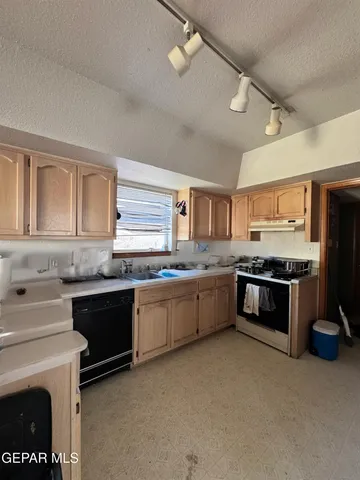 a kitchen with stainless steel appliances granite countertop a stove sink and cabinets