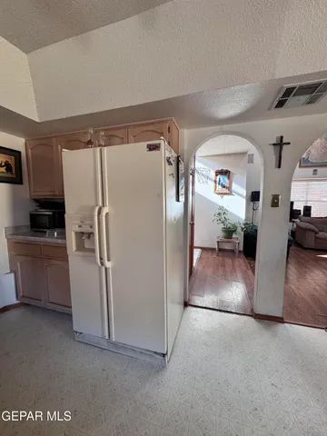 a view of a refrigerator and a refrigerator in a kitchen
