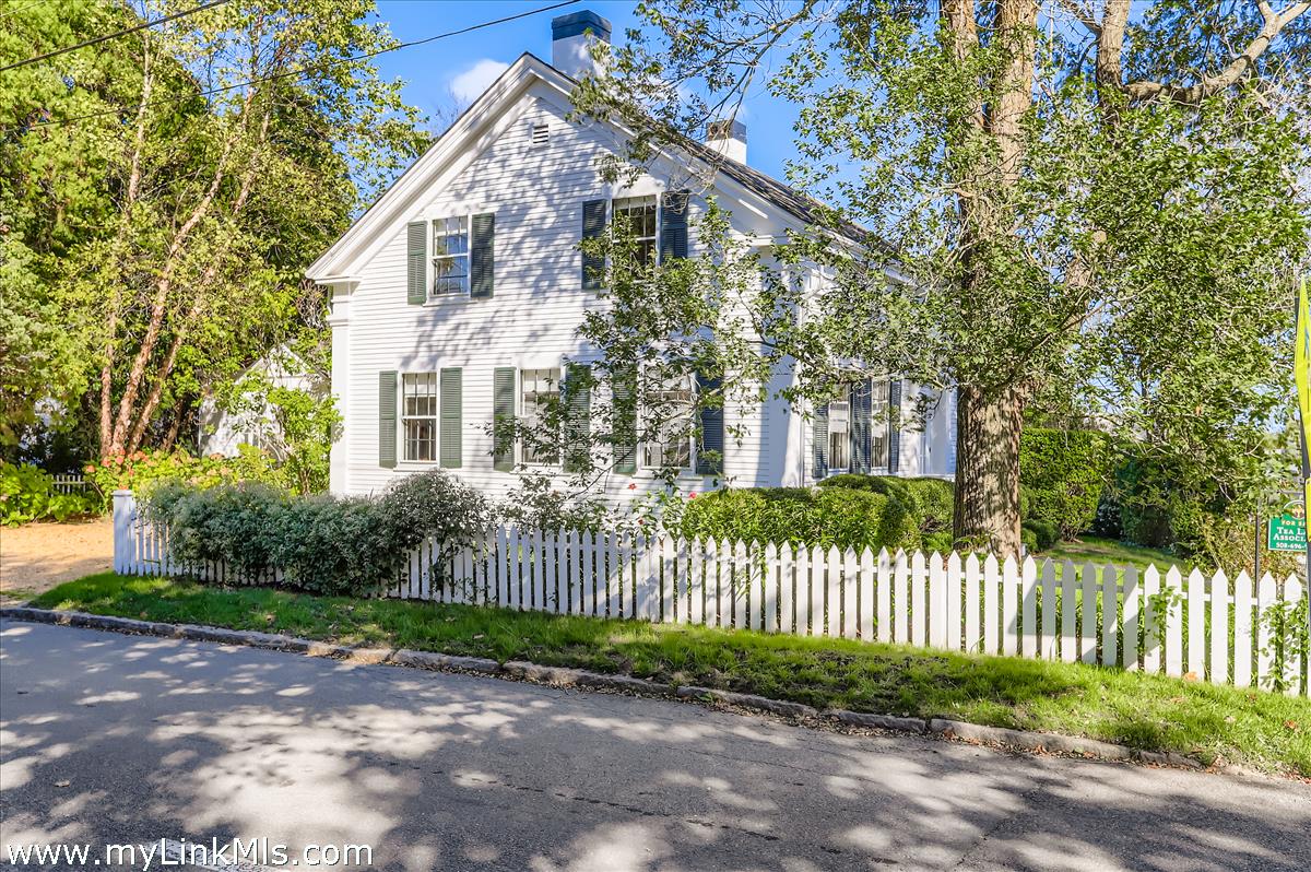 27 Spring Street Vineyard Haven, MA 02568 - Photo 2 of 58 a front view of a house with iron fence
