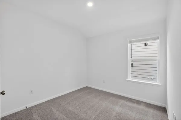 a view of an empty room and a window
