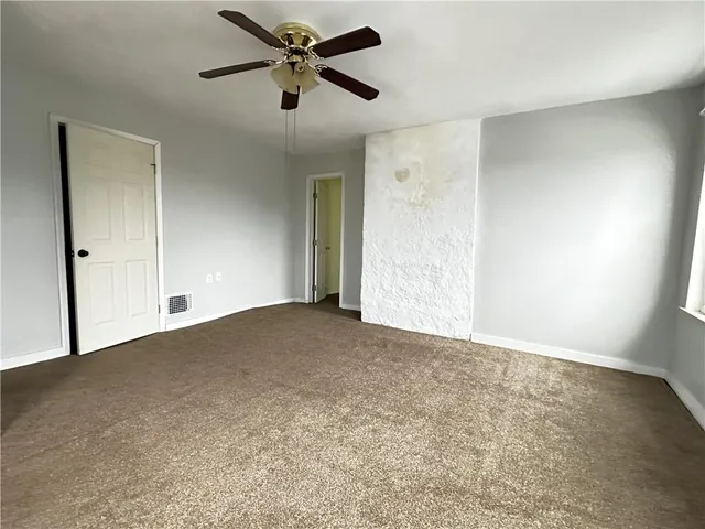 a view of a big room with carpet