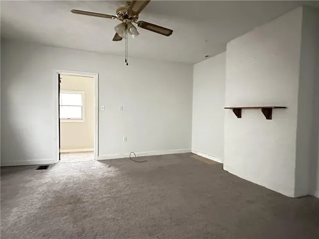 an empty room with windows and closet