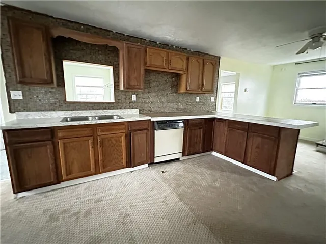 a kitchen with stainless steel appliances granite countertop wooden cabinets a sink and dishwasher