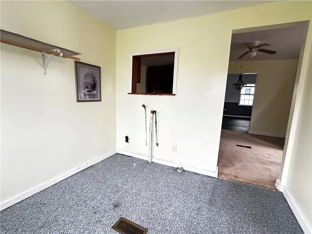 a view of a livingroom with wooden floor and windows