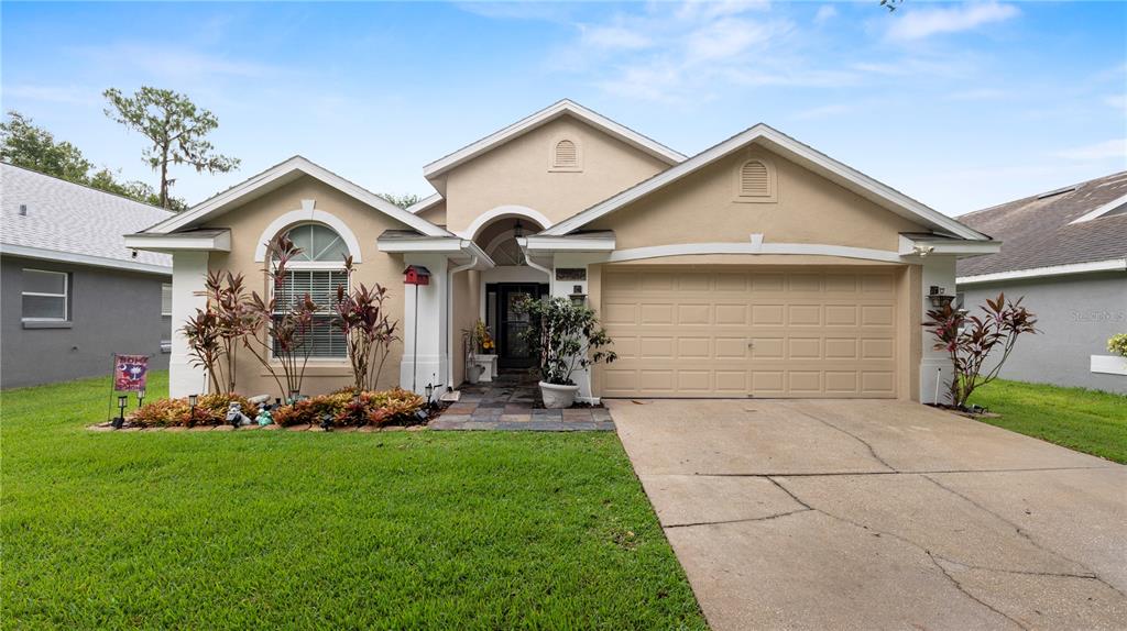 a front view of a house with a yard and garage