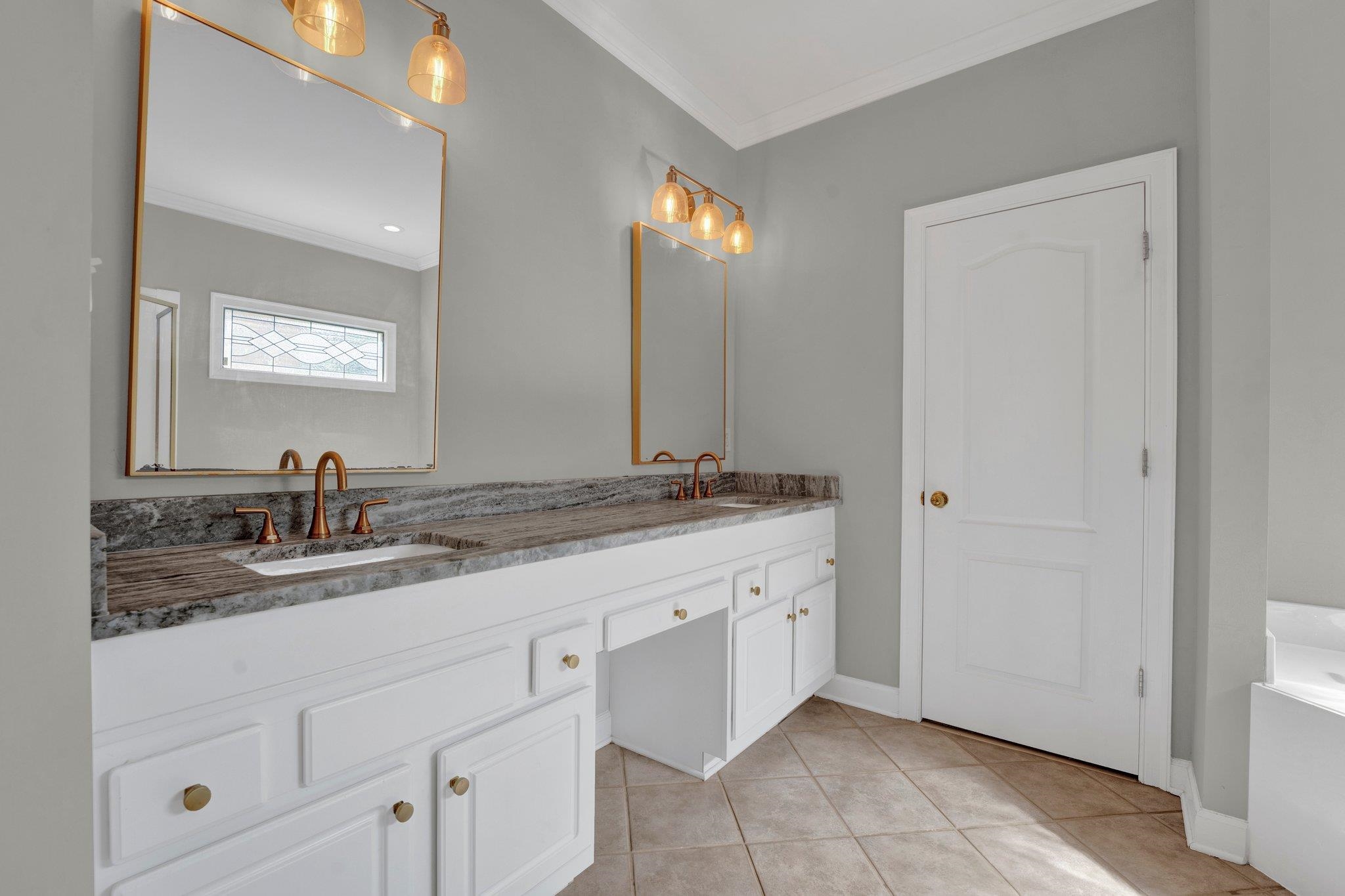 1331 Riding Brook Drive Collierville, TN 38017 - Photo 22 of 39 Bathroom with tile patterned floors, crown molding, and dual bowl vanity