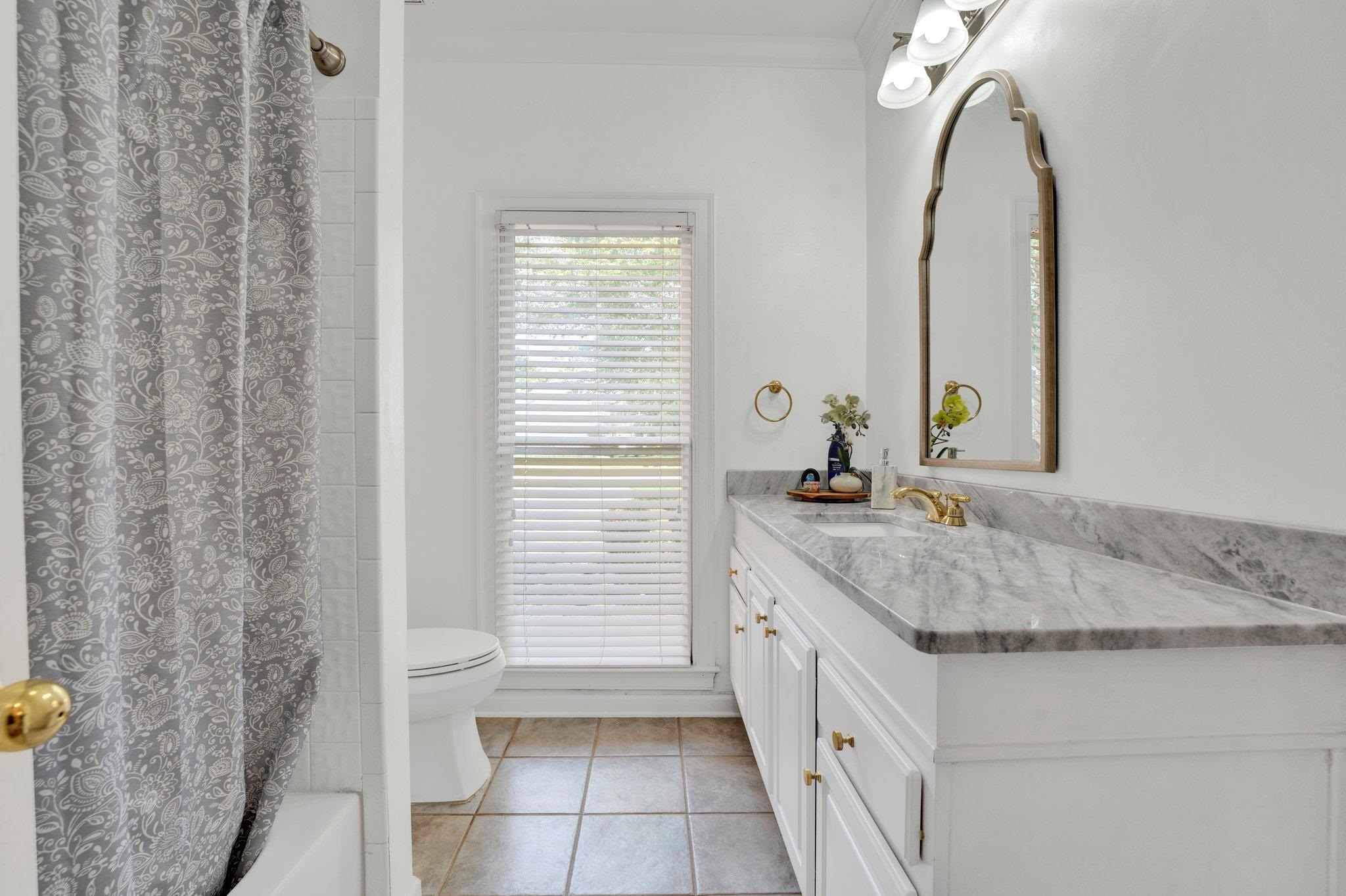 1331 Riding Brook Drive Collierville, TN 38017 - Photo 25 of 39 Full bathroom featuring toilet, vanity, shower / tub combo with curtain, tile patterned floors, and ornamental molding