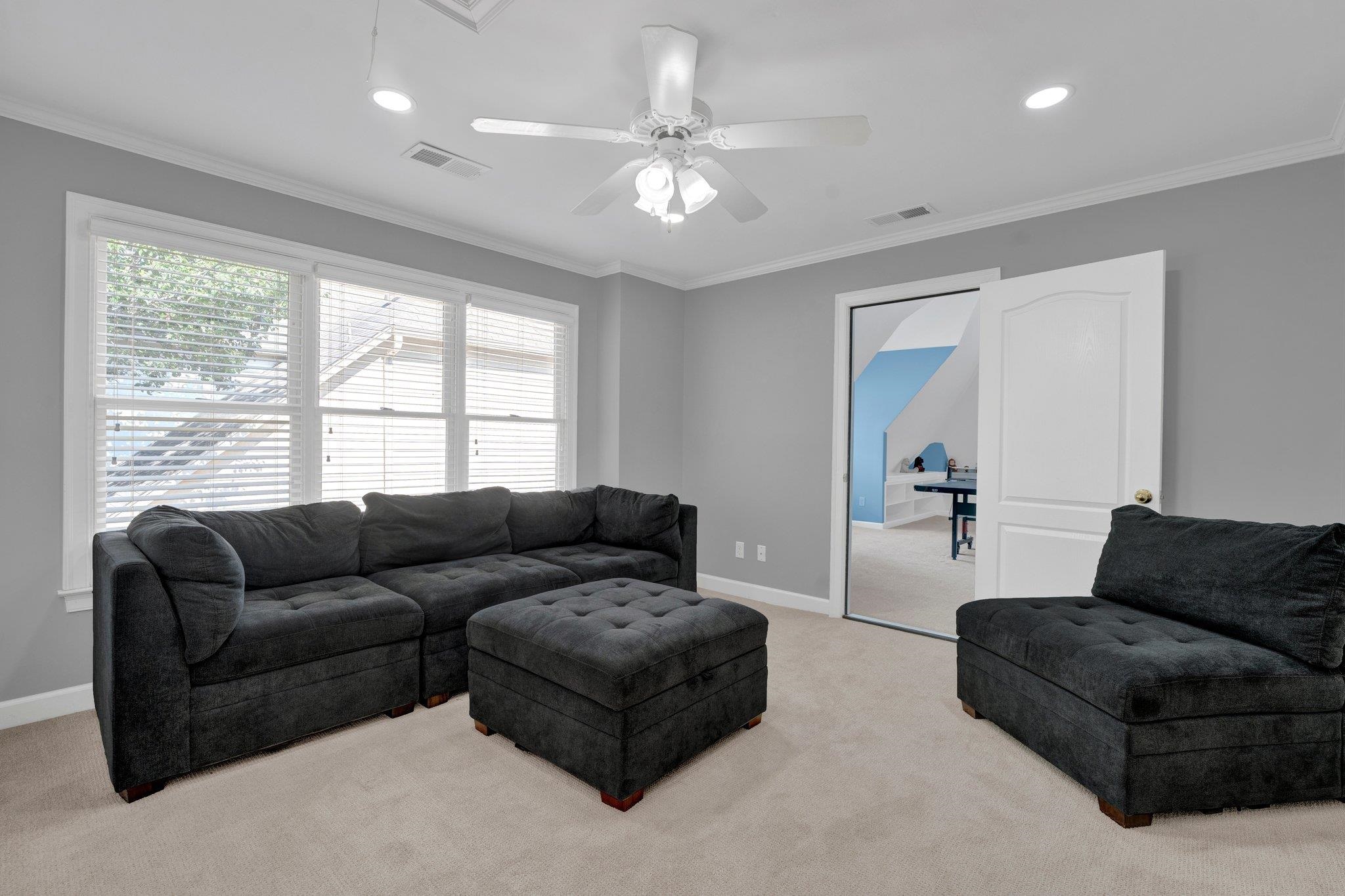 1331 Riding Brook Drive Collierville, TN 38017 - Photo 30 of 39 Living room featuring ornamental molding, light carpet, and ceiling fan