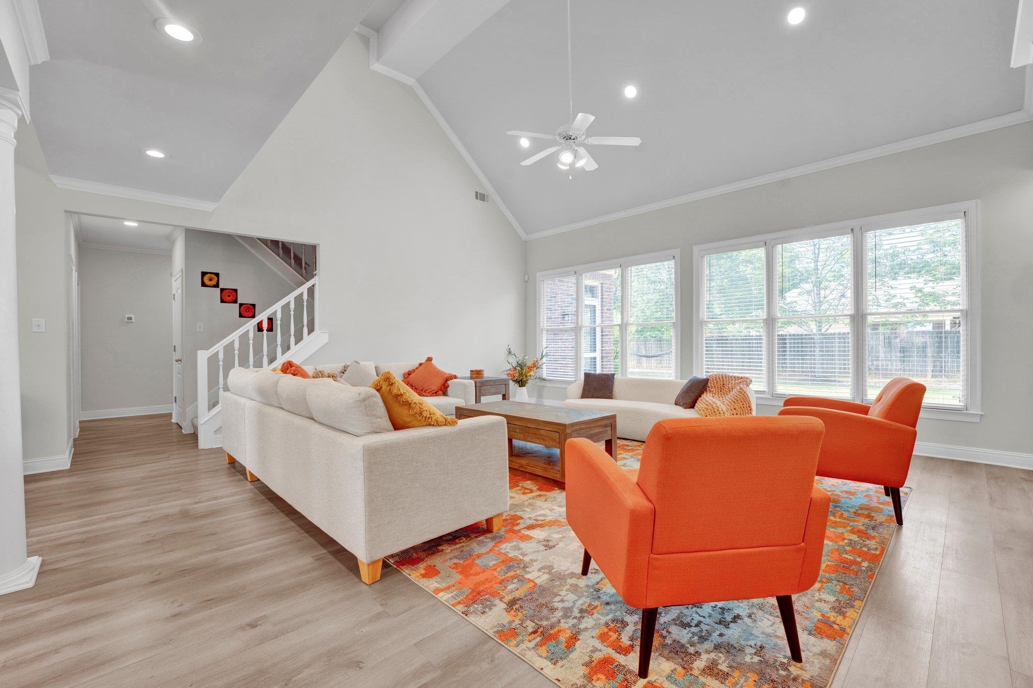 1331 Riding Brook Drive Collierville, TN 38017 - Photo 5 of 39 Living room with high vaulted ceiling, light wood-type flooring, ceiling fan, and ornamental molding