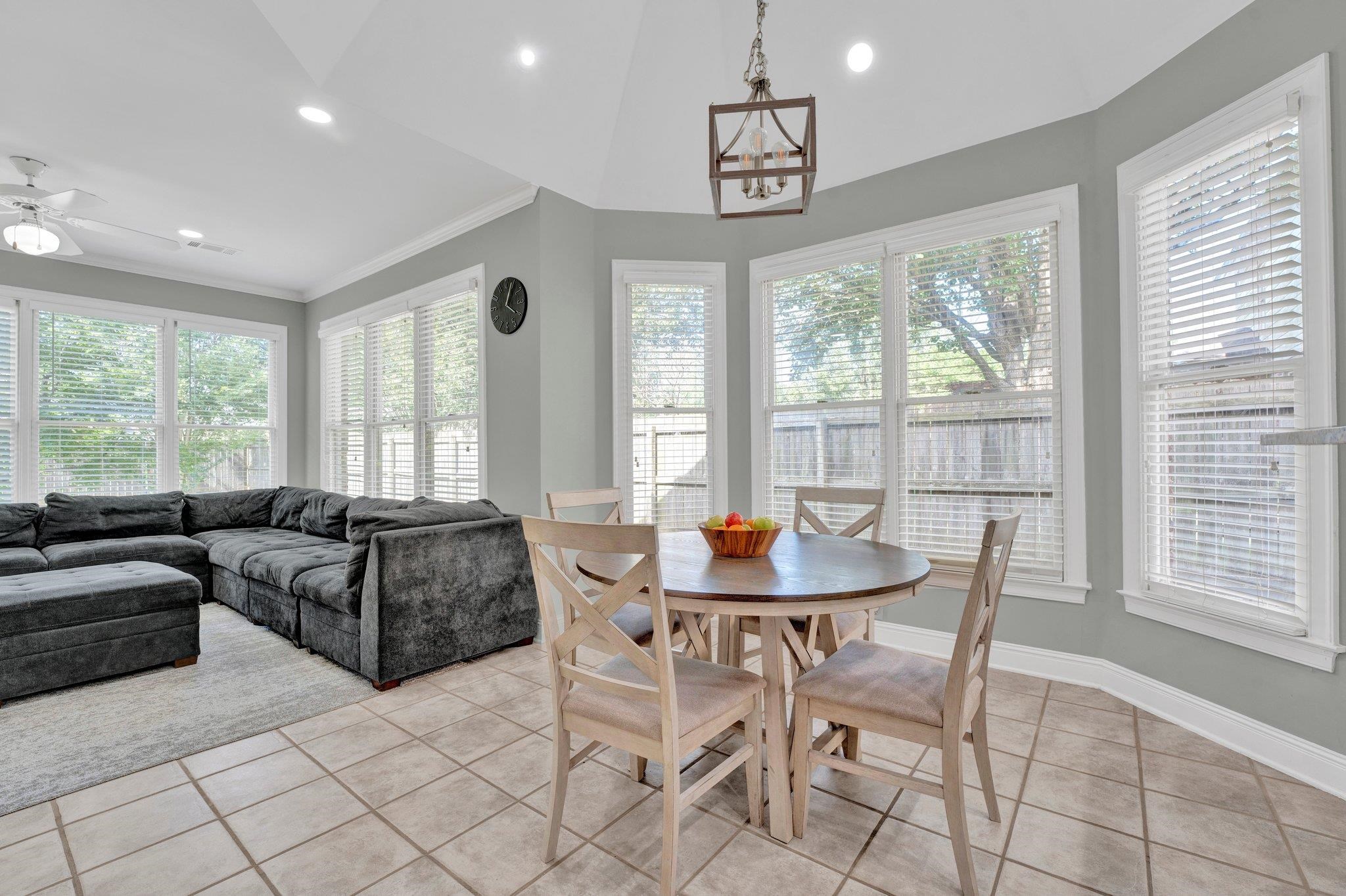 1331 Riding Brook Drive Collierville, TN 38017 - Photo 10 of 39 Tiled dining space featuring ceiling fan, vaulted ceiling, and crown molding