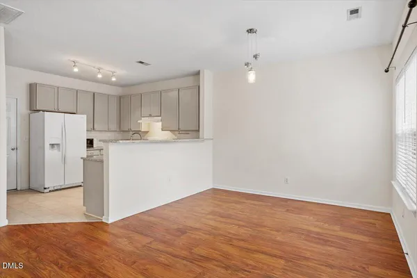 a view of a kitchen with wooden floor