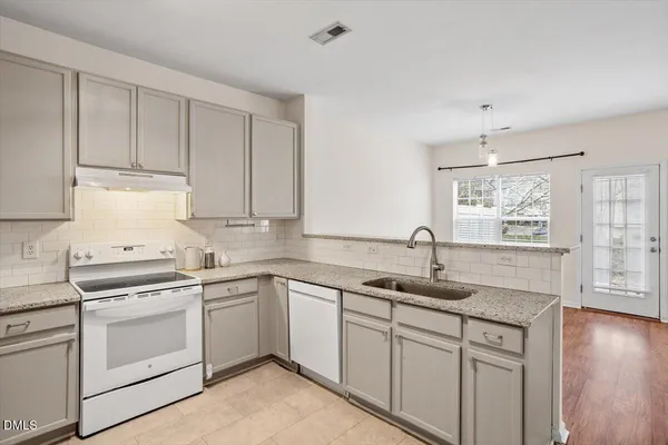 a kitchen with a sink cabinets and window