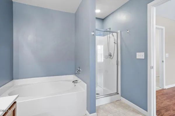 a bathroom with a tub shower and sink