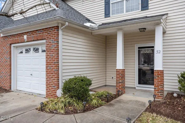 a view of a house with potted plants