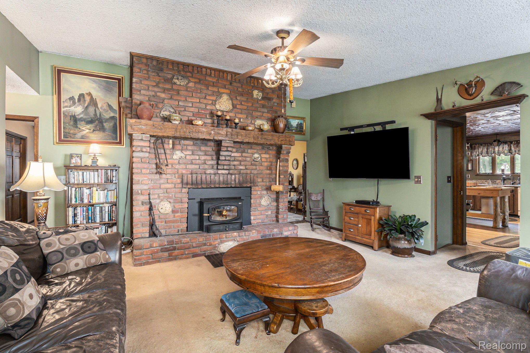 7280 Groveland Road Holly, MI 48442 - Photo 9 of 48 living room with wood burning system