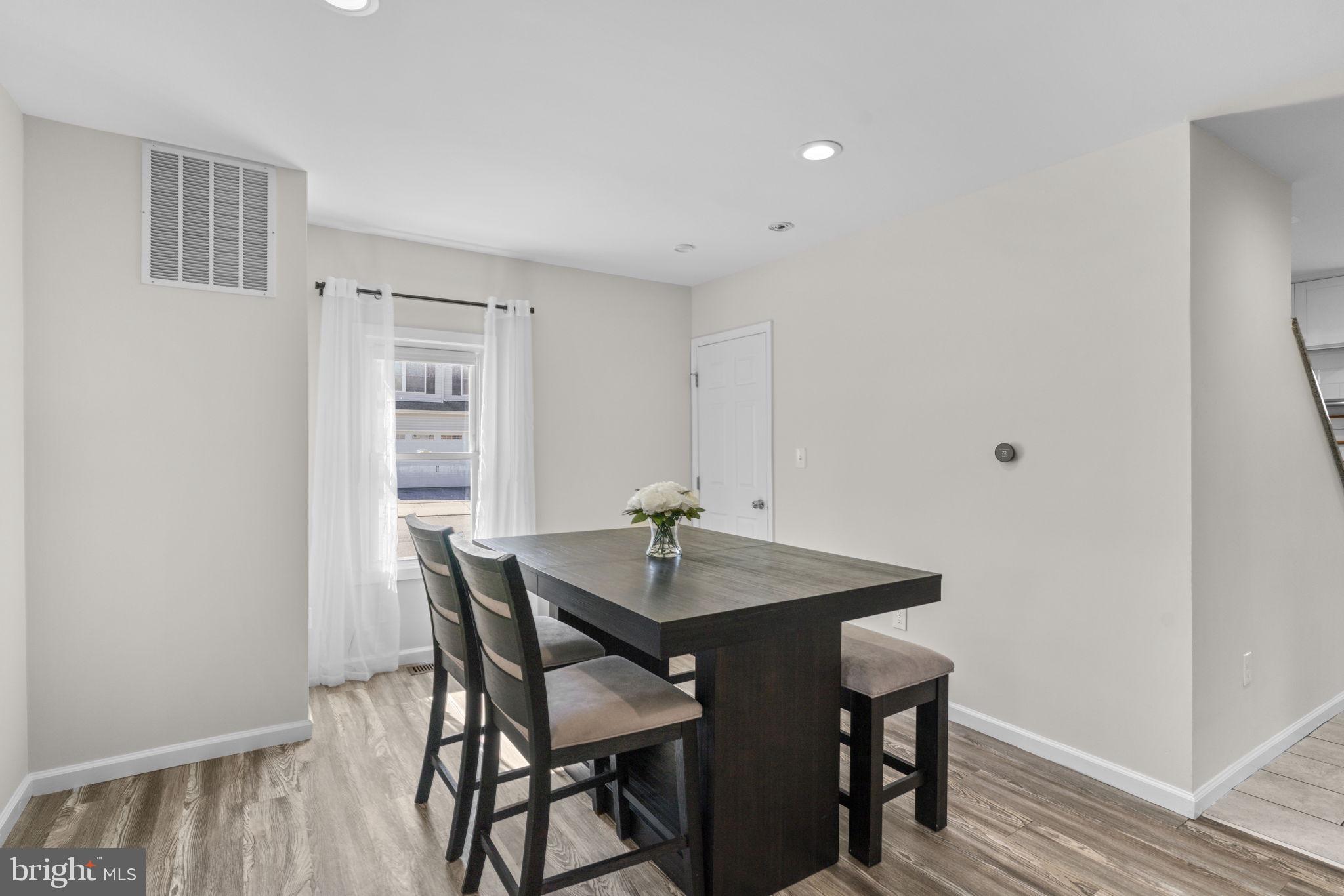 8062 Telegraph Road Severn, MD 21144 - Photo 13 of 45 a view of a dining room with furniture and wooden floor