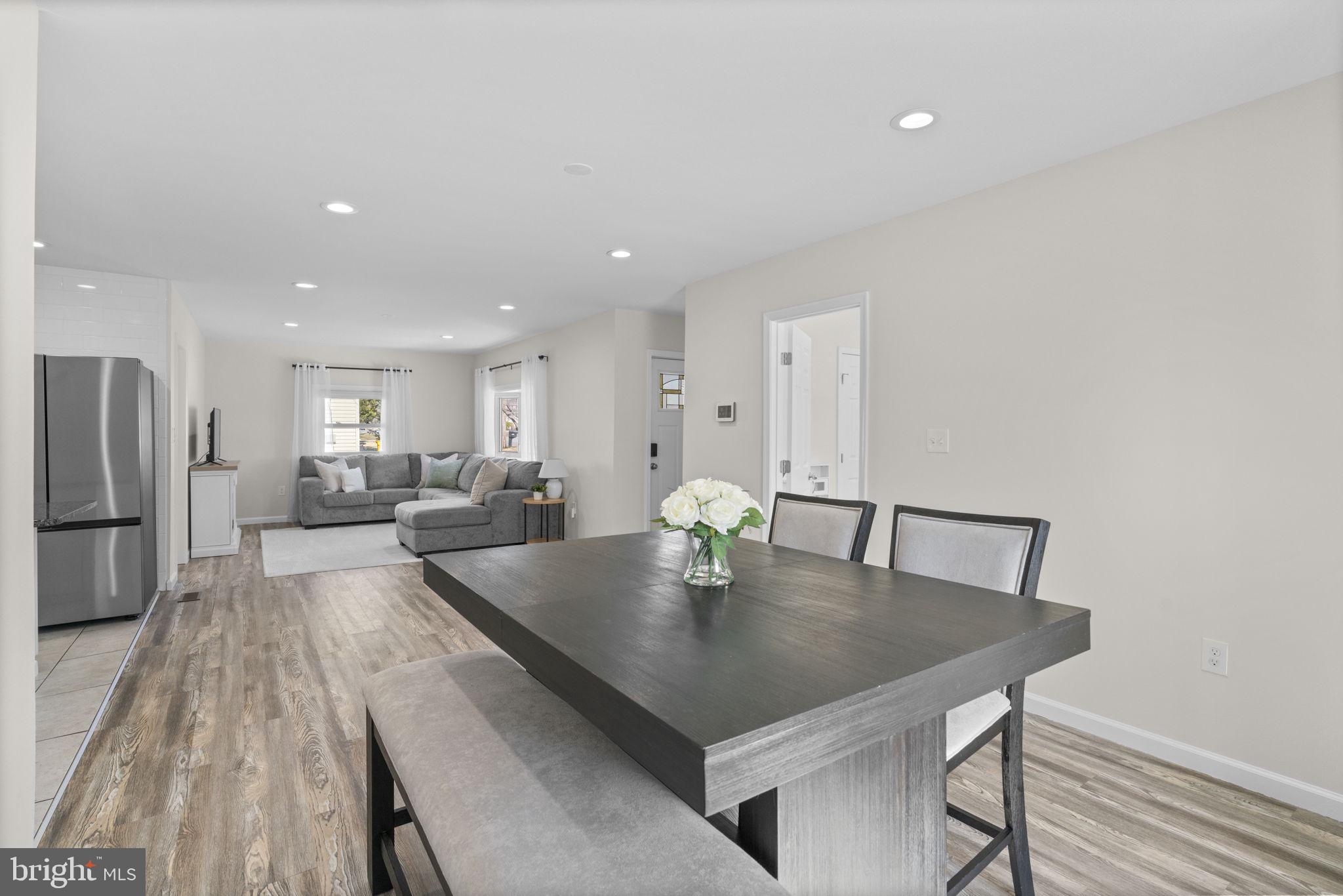 8062 Telegraph Road Severn, MD 21144 - Photo 14 of 45 a living room with stainless steel appliances furniture a dining table and chairs