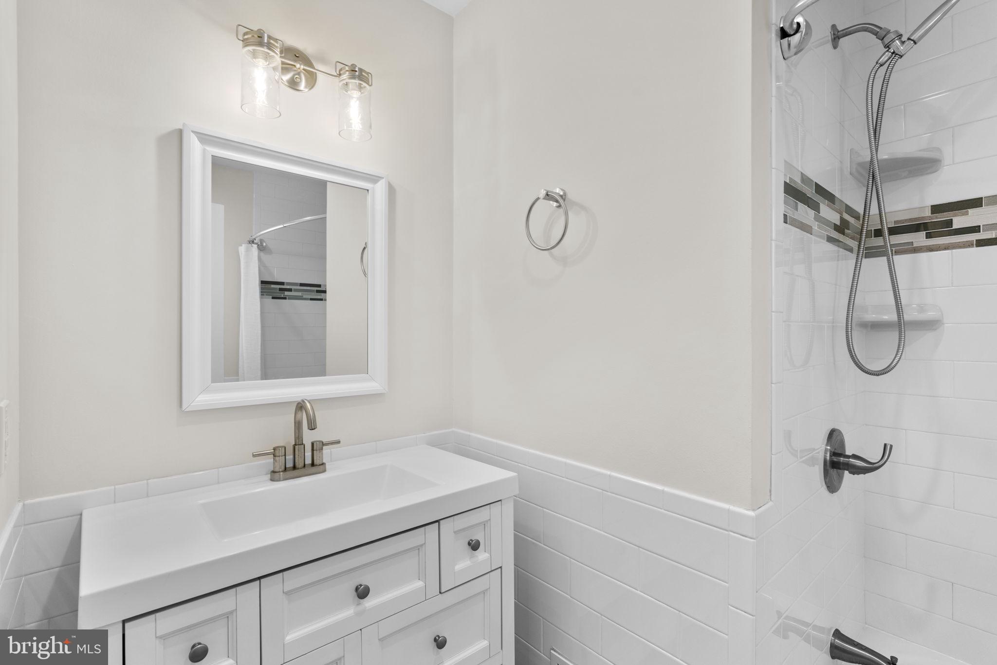 8062 Telegraph Road Severn, MD 21144 - Photo 18 of 45 a bathroom with a sink vanity and mirror
