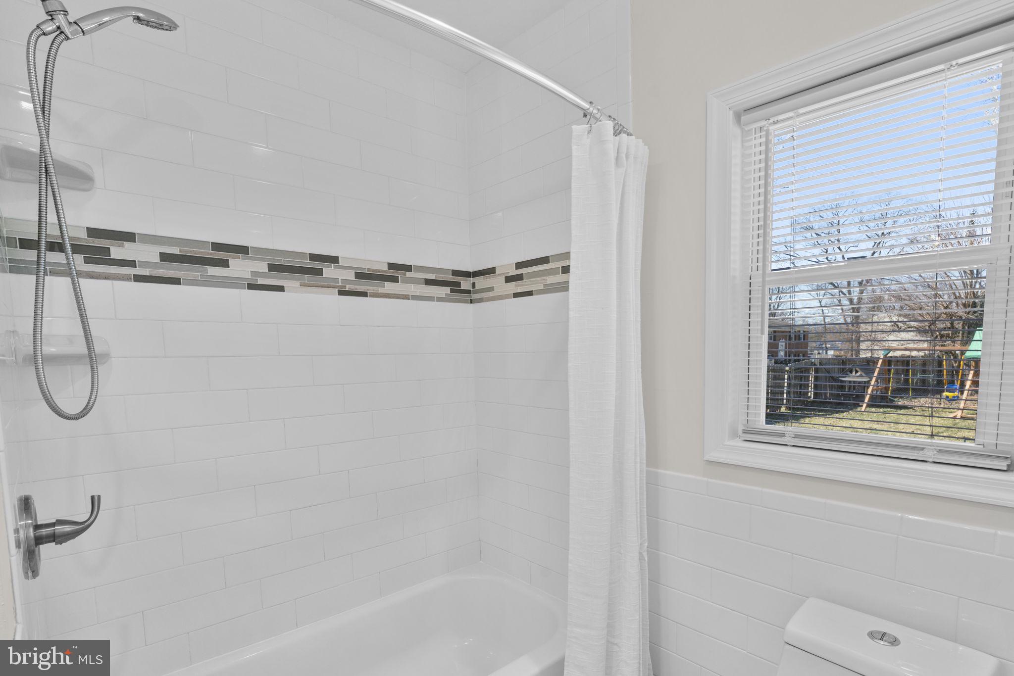 8062 Telegraph Road Severn, MD 21144 - Photo 19 of 45 a bathroom with a shower and a toilet