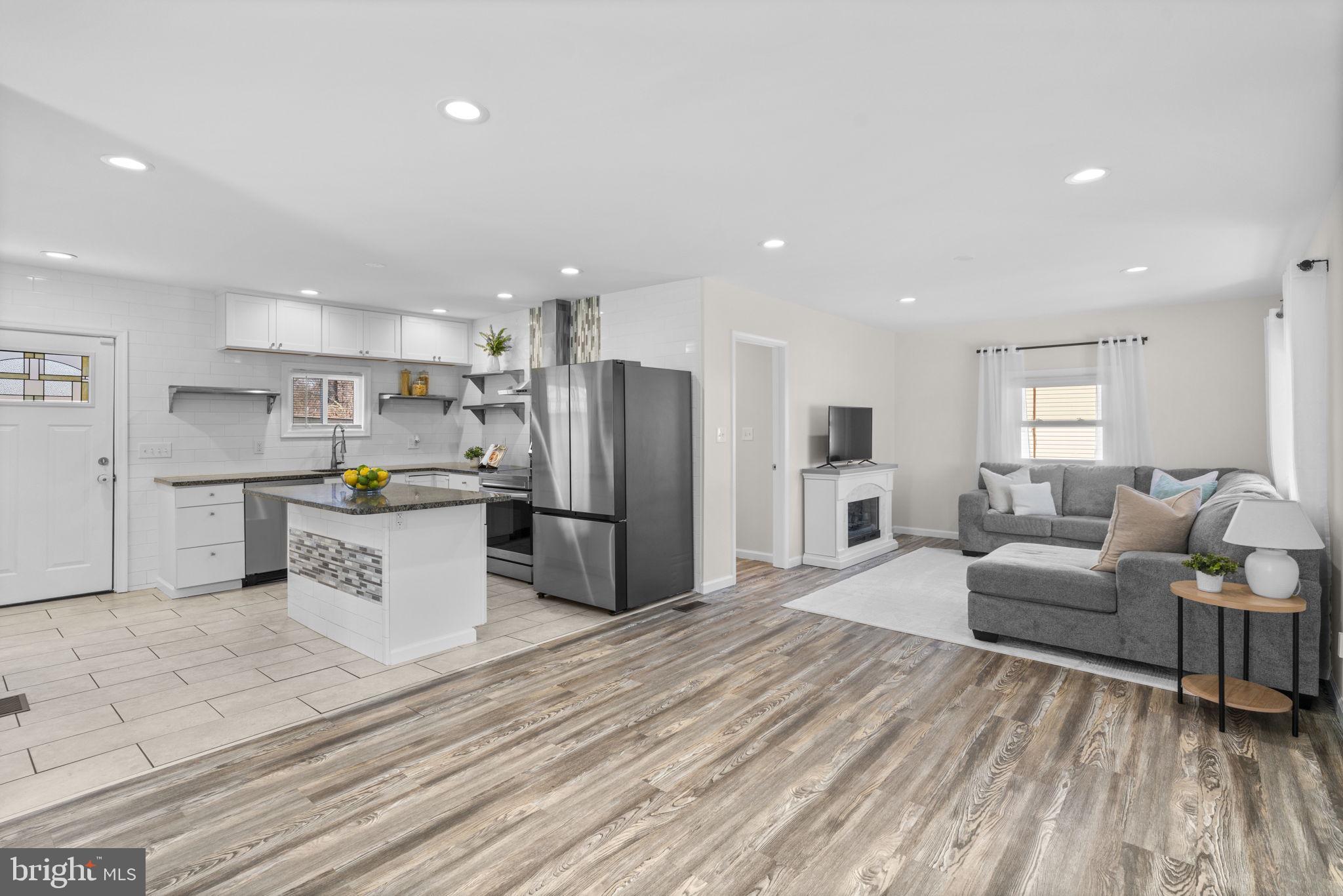 8062 Telegraph Road Severn, MD 21144 - Photo 41 of 45 a large kitchen with stainless steel appliances lots of white cabinets appliances a sink and a center island