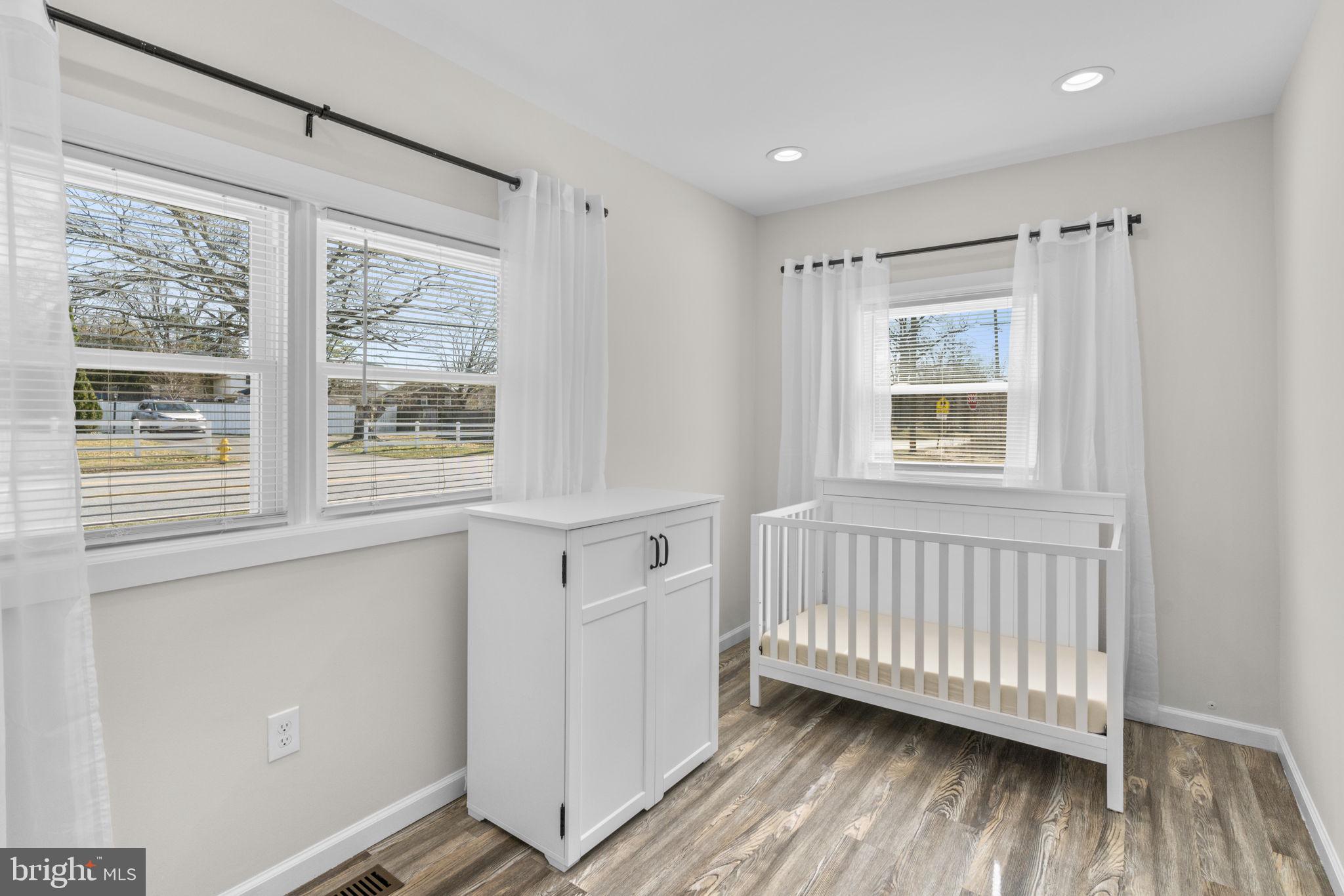 8062 Telegraph Road Severn, MD 21144 - Photo 20 of 45 a view of an empty room with wooden floor and a window