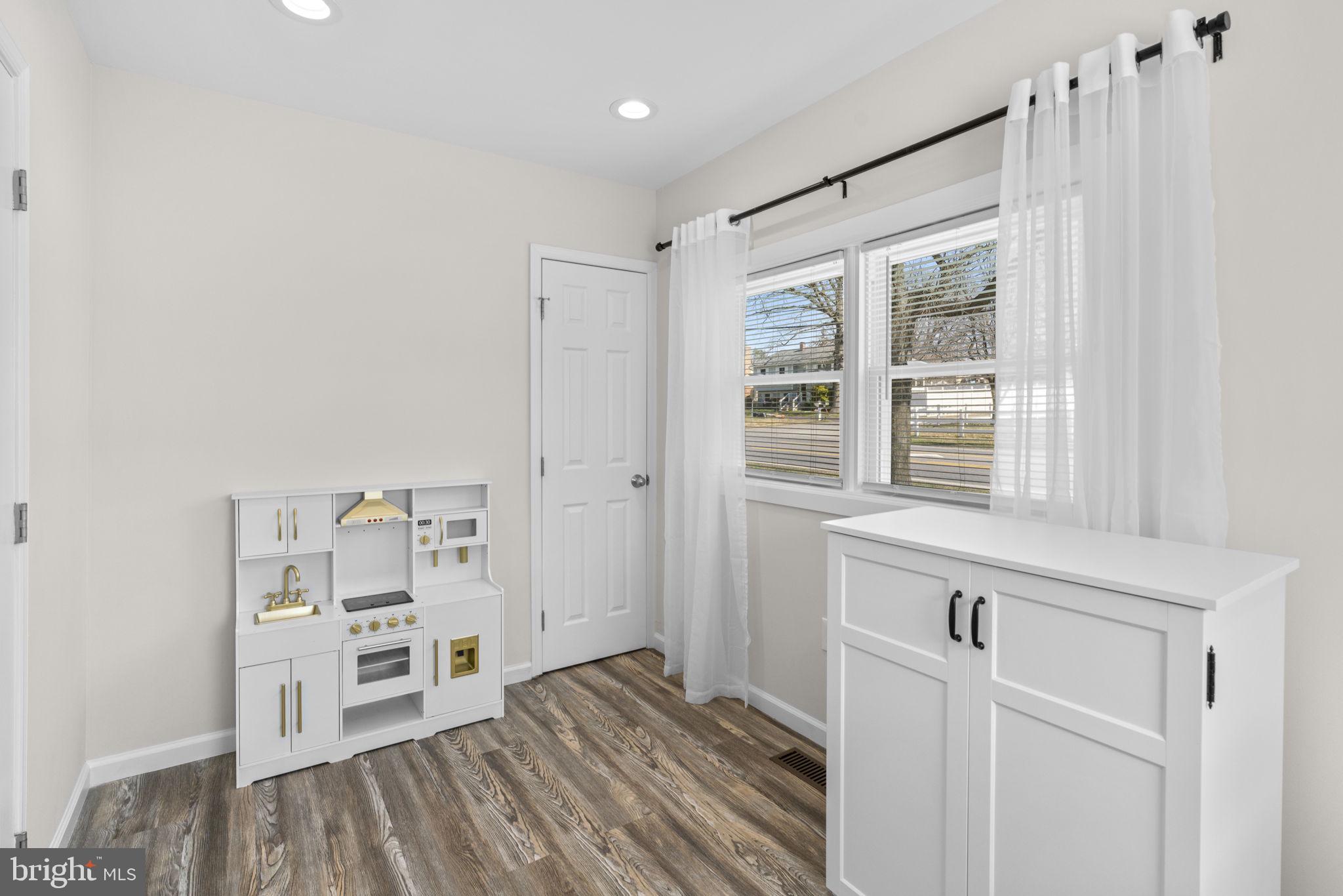 8062 Telegraph Road Severn, MD 21144 - Photo 22 of 45 a view of wooden floor and windows in a room