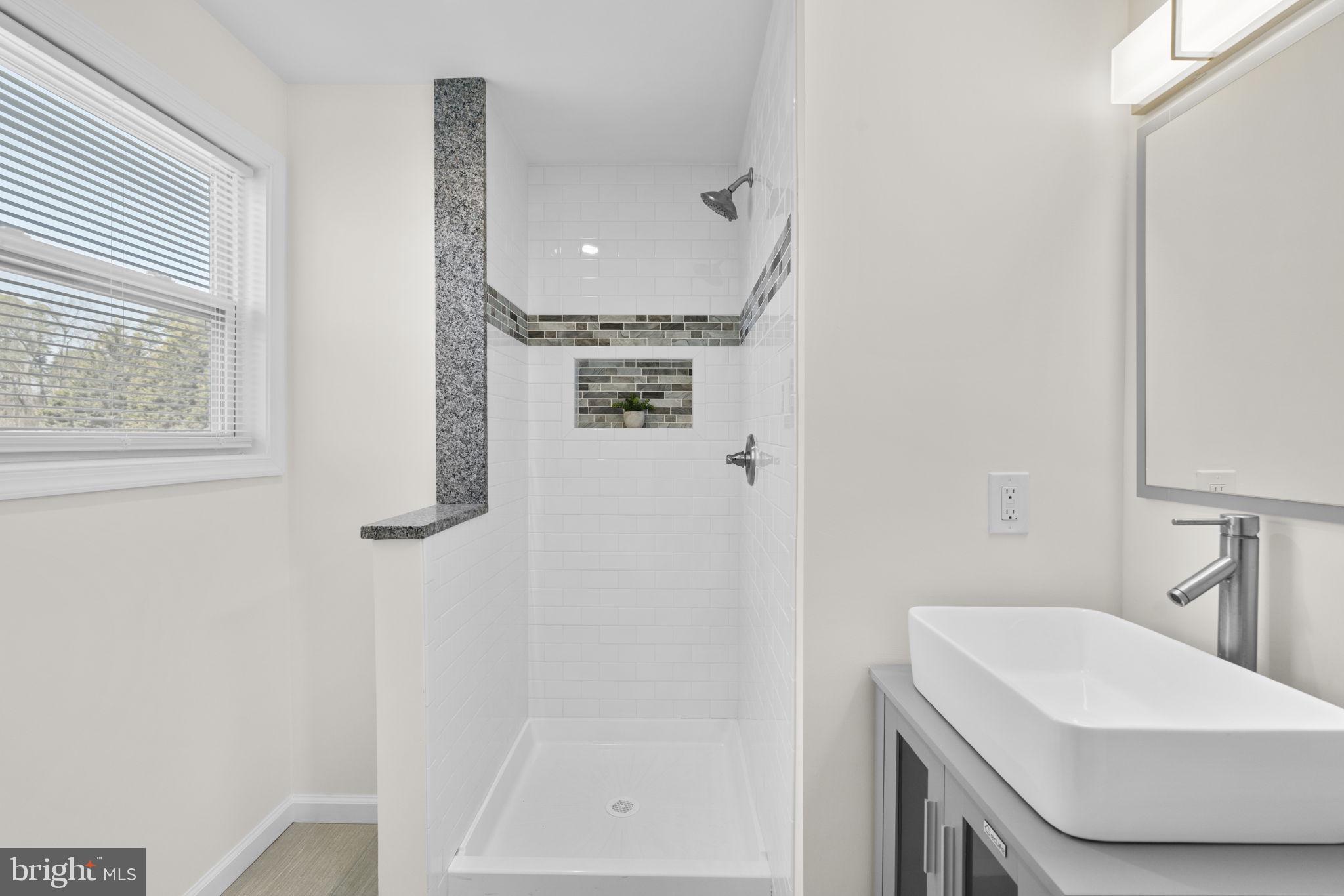 8062 Telegraph Road Severn, MD 21144 - Photo 28 of 45 a bathroom with a sink a toilet and shower