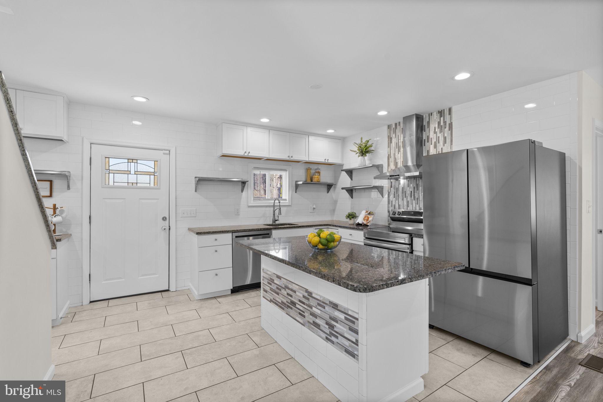 8062 Telegraph Road Severn, MD 21144 - Photo 2 of 45 a kitchen with a refrigerator a sink and a stove top oven