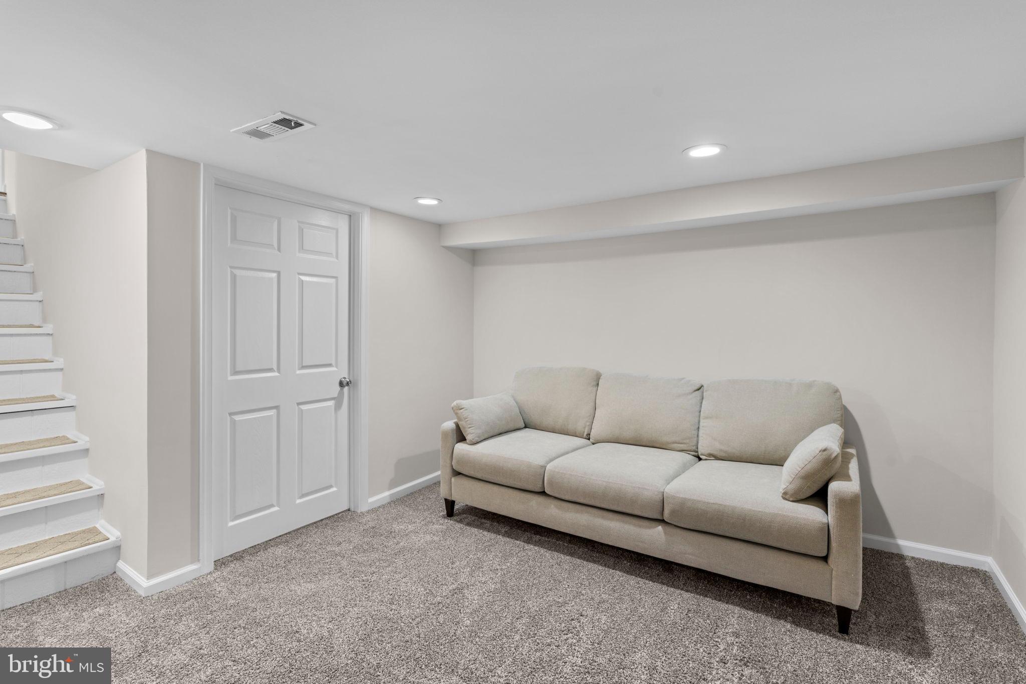 8062 Telegraph Road Severn, MD 21144 - Photo 30 of 45 a living room with furniture and a ceiling fan