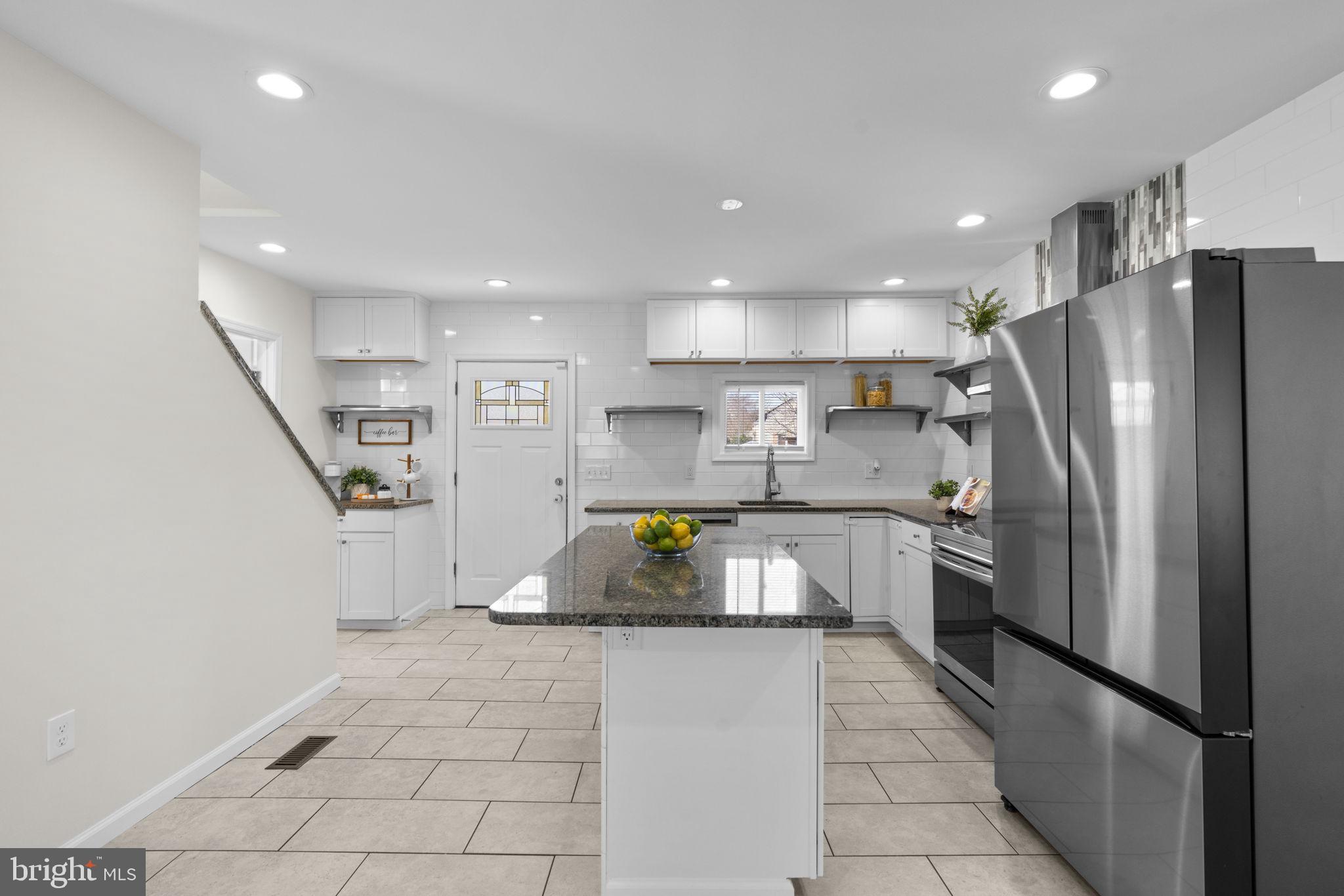 8062 Telegraph Road Severn, MD 21144 - Photo 3 of 45 a kitchen with stainless steel appliances granite countertop a refrigerator a stove and a sink