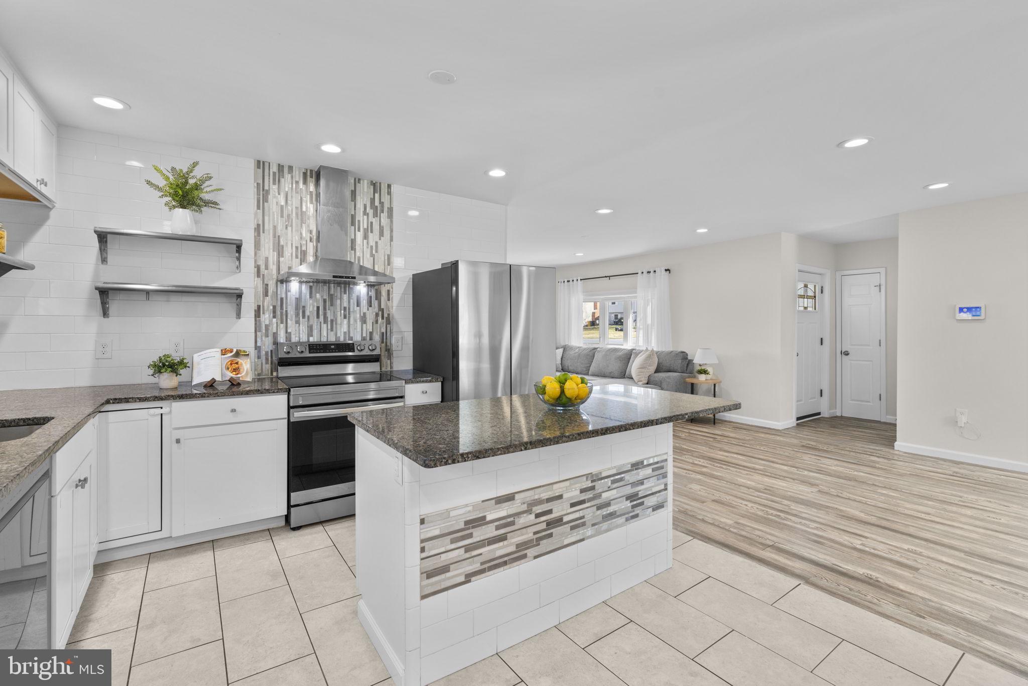 8062 Telegraph Road Severn, MD 21144 - Photo 6 of 45 a kitchen with stainless steel appliances a refrigerator sink and cabinets