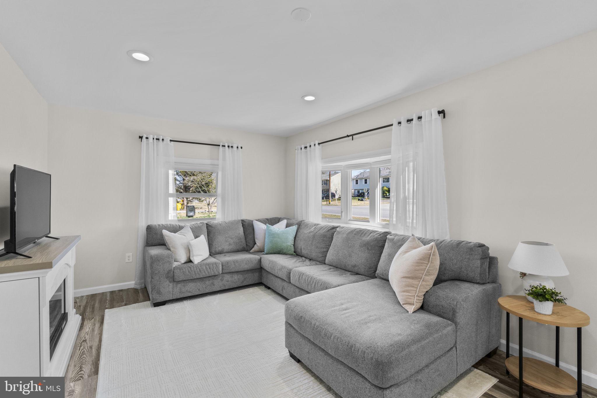 8062 Telegraph Road Severn, MD 21144 - Photo 7 of 45 a living room with furniture and a flat screen tv