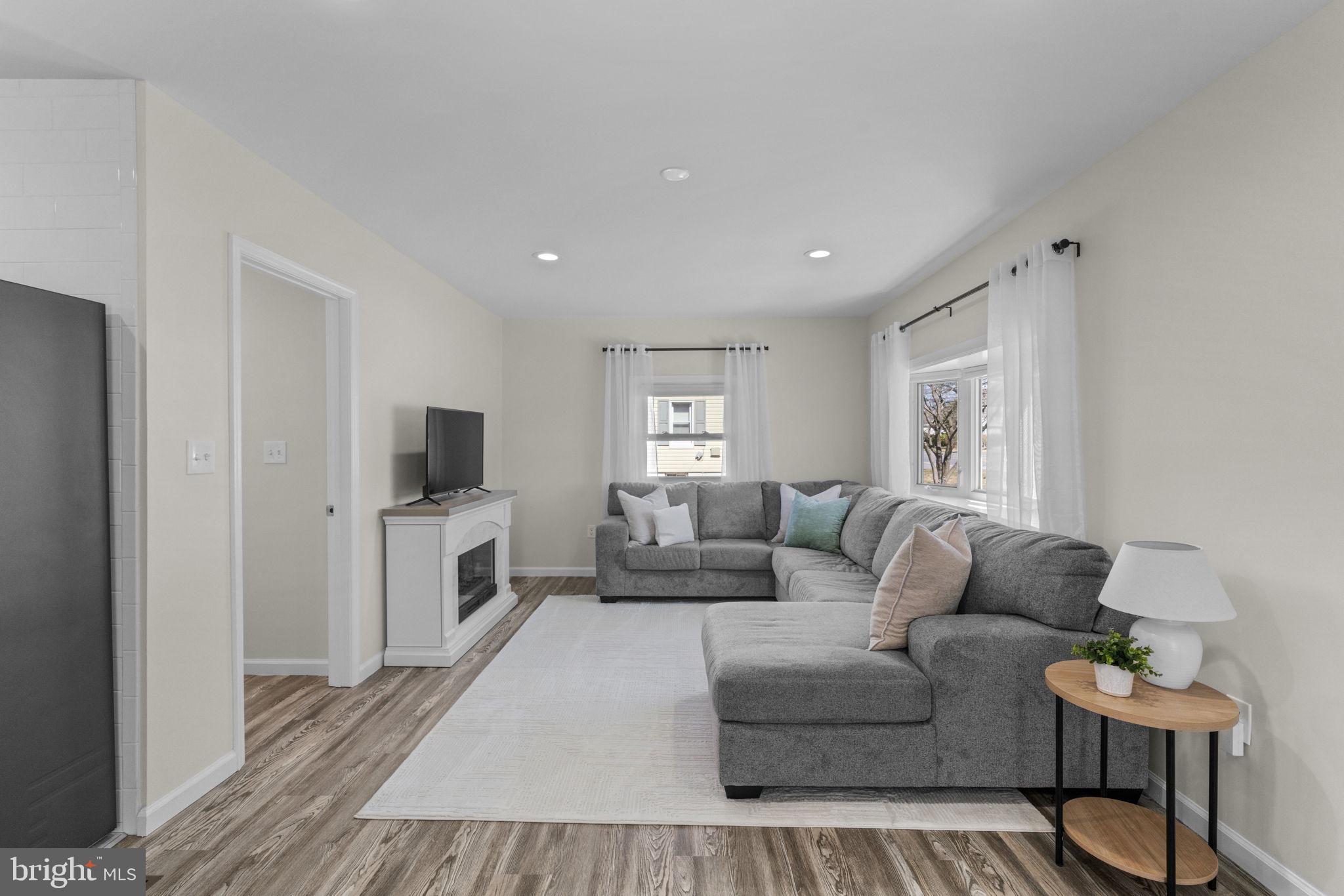 8062 Telegraph Road Severn, MD 21144 - Photo 8 of 45 a living room with furniture flat screen tv and window