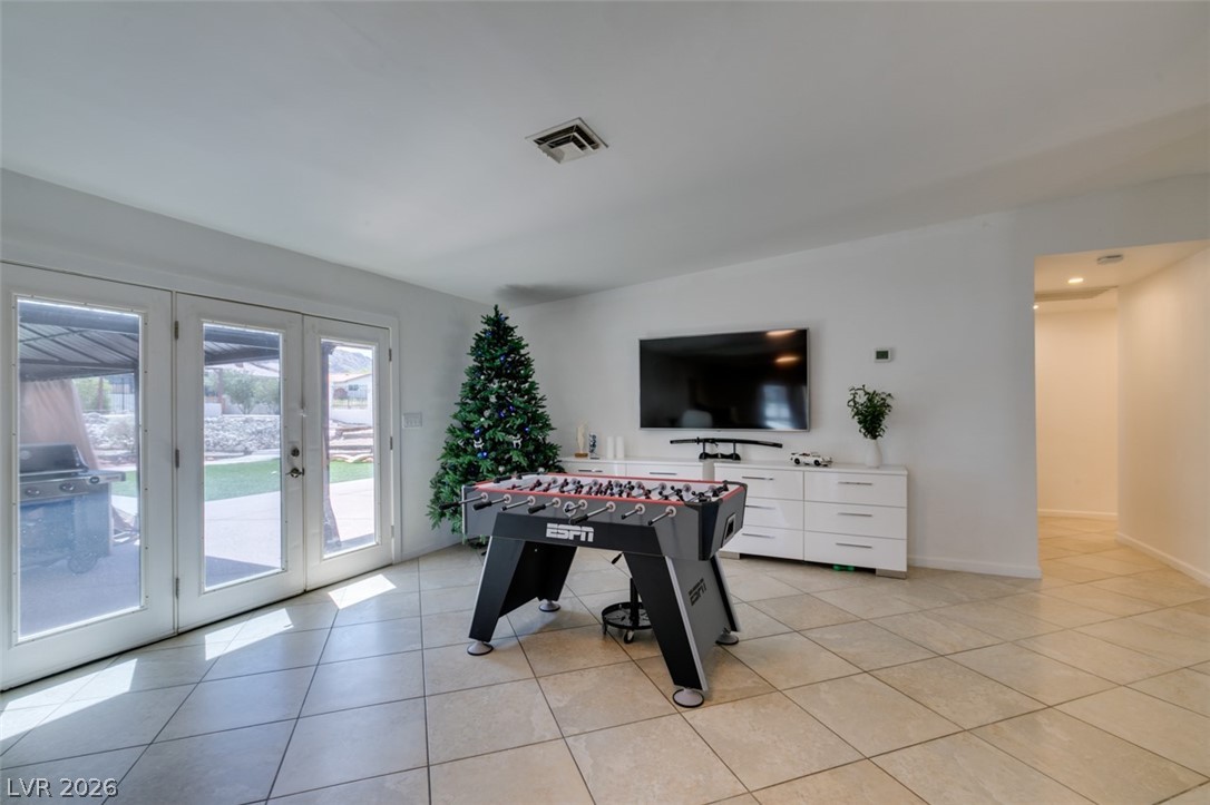 892 North Hollywood Boulevard Las Vegas, NV 89110 - Photo 25 of 81 This versatile living area seamlessly extends to outdoor leisure, perfect for relaxation and entertainment.