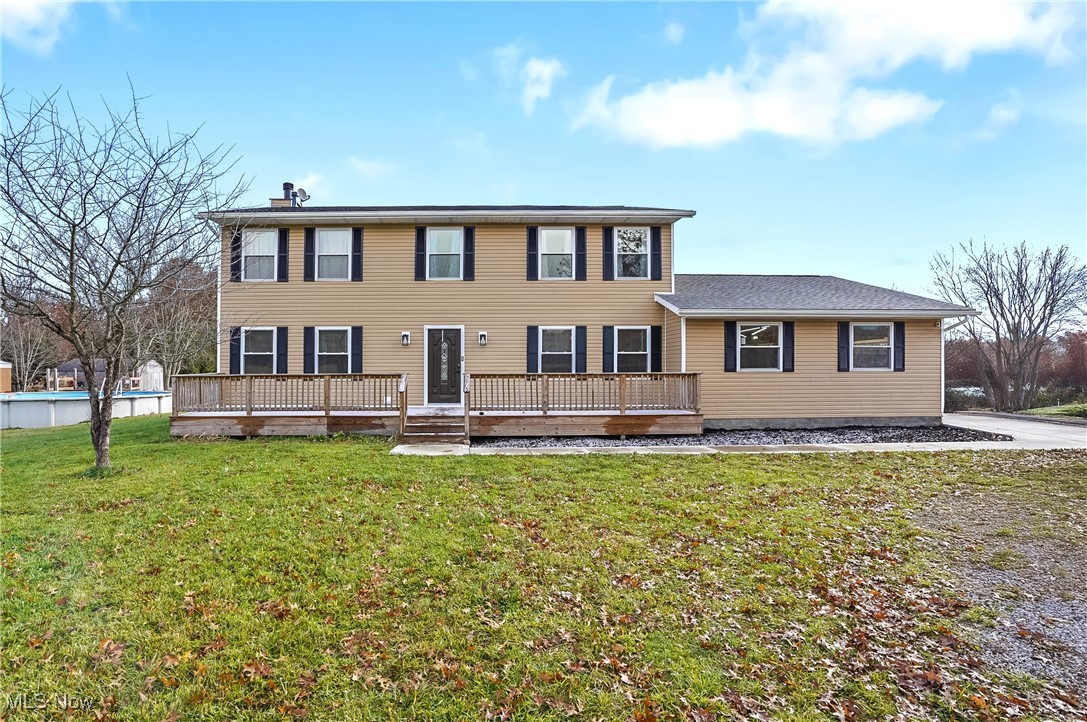 9278 Bryant Road Windham, OH 44288 - Photo 1 of 47 Colonial-style house featuring a front lawn, a chimney, and a deck