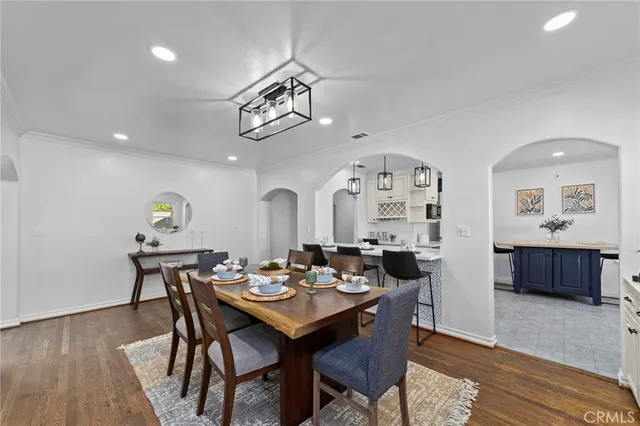 a kitchen with kitchen island a sink stainless steel appliances and cabinets