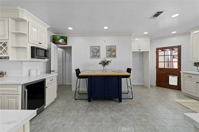 a large kitchen with a sink and cabinets